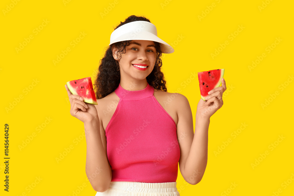 Happy young African-American woman with fresh watermelon on yellow background Happy young African-American woman with fresh watermelon on yellow background