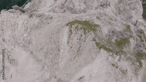 Wallpaper Mural Aerial footage flying over the craggy and barren points of mountains revealing a green valley below in northern Italy. Torontodigital.ca