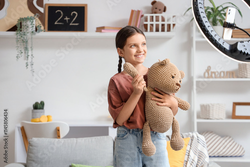Teenage blogger with toy be...