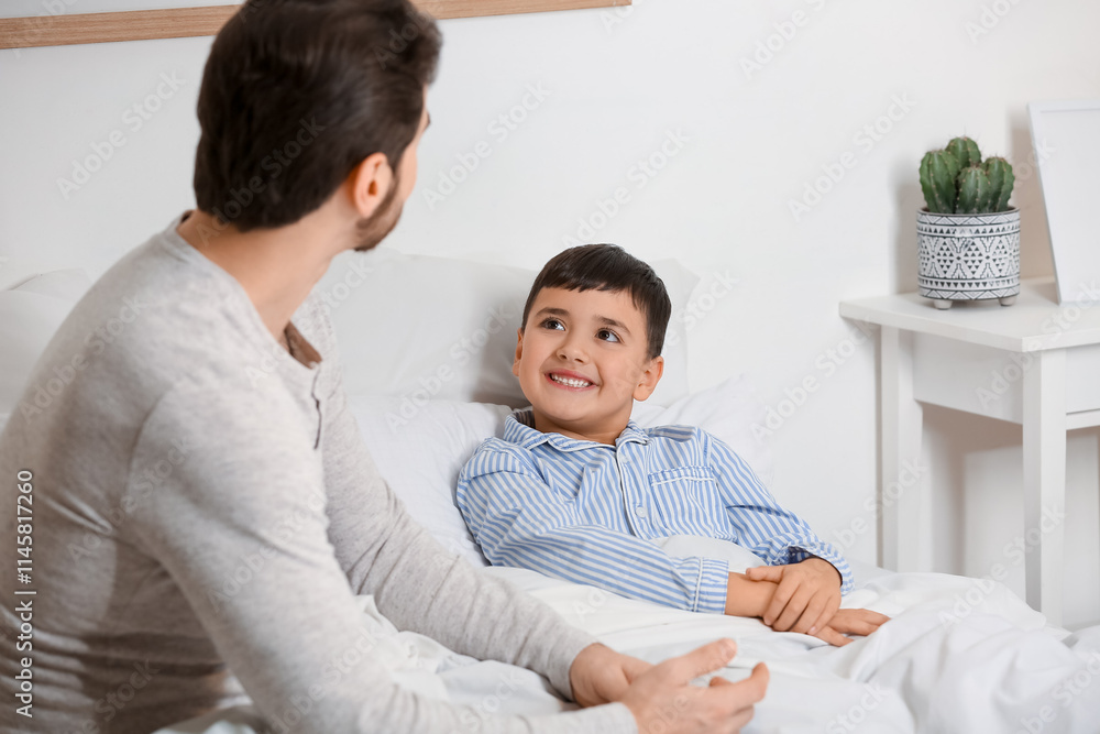 Father with his little son lying in bedroom Father with his little son lying in bedroom