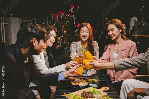 A lively group of friends enjoying beers at a festive pub, toasting with frosty pints. The scene captures the joy of friendship, culture, and celebration over drinks and appetizers on a sunny terrace. photo