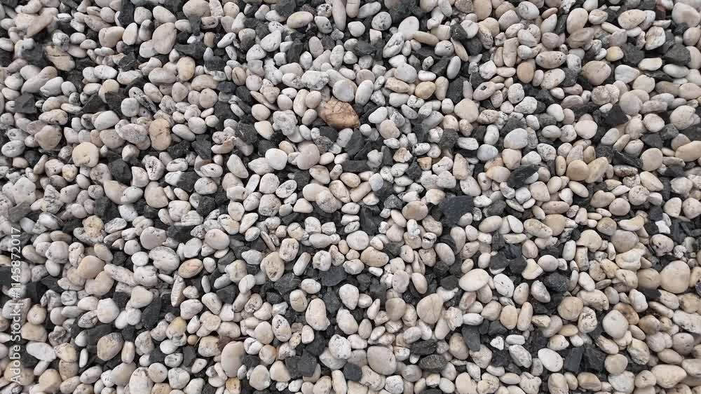 Pebble Beach Texture: A close-up of smooth, weathered pebbles in shades of white, gray, and black, creating a natural, textural background. Perfect for design projects, website backgrounds. Pebble Beach Texture: A close-up of smooth, weathered pebbles in shades of white, gray, and black, creating a natural, textural background. Perfect for design projects, website backgrounds.