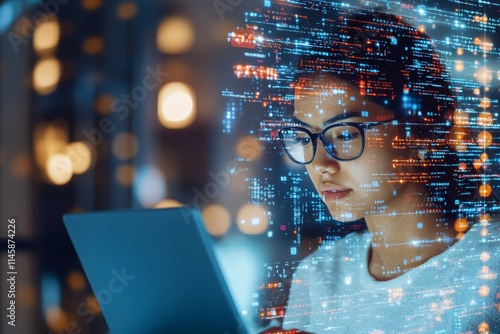 Focused individual using a laptop in a modern, illuminated environment with digital data overlays