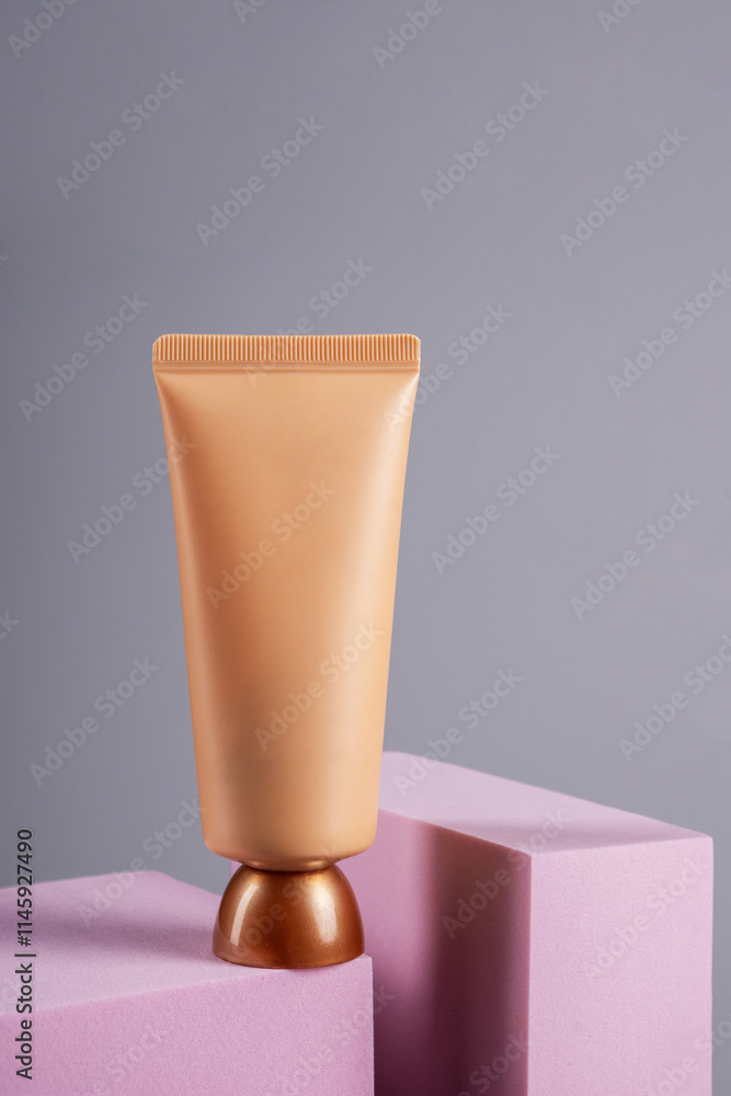 Plastic tube for cream or lotion. Skin care or sunscreen cosmetic with stylish props on grey background. Plastic tube for cream or lotion. Skin care or sunscreen cosmetic with stylish props on grey background.