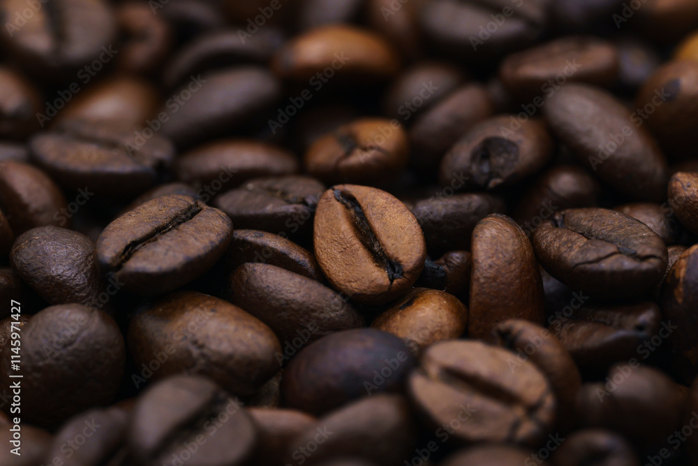 Naklejka premium beautiful picture, background with coffee beans, close-up of spilled coffee, a mixture of robusta and Arabica
