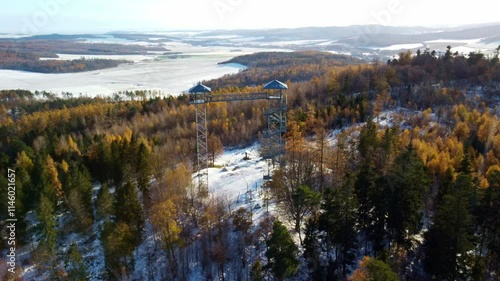 Aerial view of Boundary Peak or Hraniční Vrch observation tower in snow-covered forests of Albrechtice, Czech Republic photo