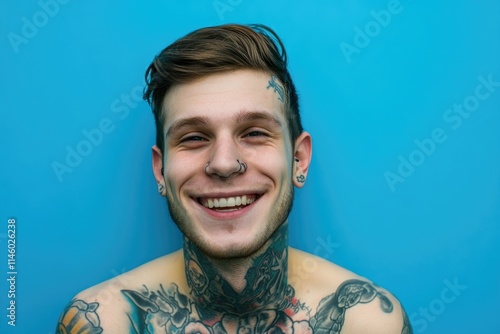 Vibrant Contemporary Portrait of a Tattooed Young Adult Against Blue Background photo