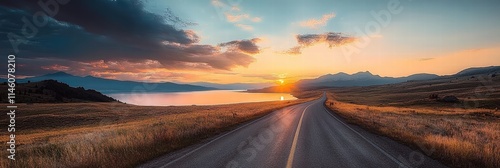 Stunning Sunset Over Serene Landscape with Open Road and Calm Water Reflections in National Park Setting