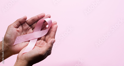 Pink Breast Cancer Awareness Ribbon. Hands holding pink ribbon on backgrounds. Breast cancer awareness and October Pink day, world cancer day. Top view. Mock up. photo