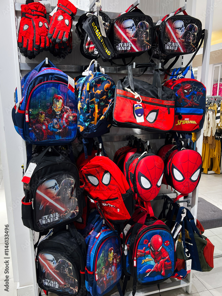 Obraz premium Kyiv, Ukraine - December 18, 2024: Colorful display of superhero-themed backpacks and handbags in retail store setting