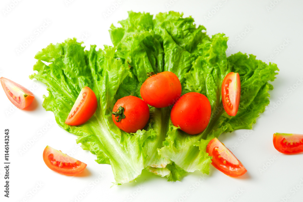 green raw lettuce and slice of tomato pile to make a salad and sandwich isolated on white background green raw lettuce and slice of tomato pile to make a salad and sandwich isolated on white background