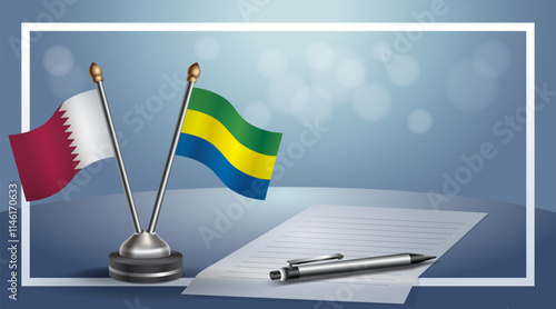 Qatar and Gabon National flags on small table with bokeh background, cooperative relationship