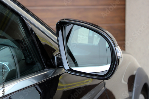 Black car Rearview car driving mirror. View from inside the car. Side rear-view mirror on a modern car. Look rear view mirror.