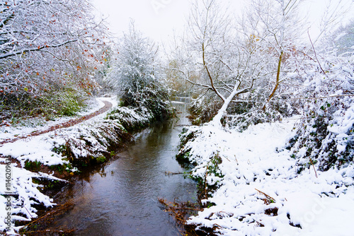 The River Leen flowing through a snow covered landscape.