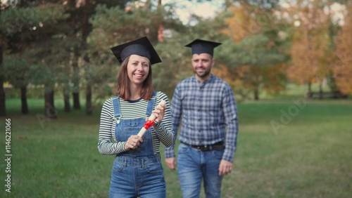 A truly joyous graduation moment has been beautifully captured in a lovely park surrounded by close friends