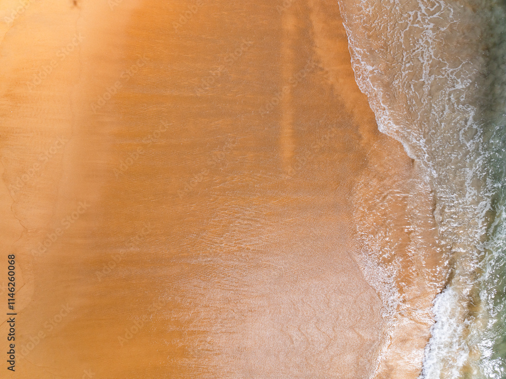 Fototapeta premium Amazing Top view sand beach landscape background,Summer sea waves crashing on sandy shore seascape background,High angle view ocean nature beach background