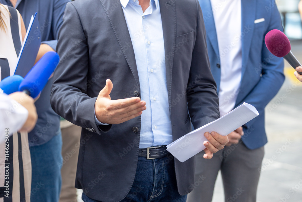 Unrecognizable person or whistleblower holding confidential document and giving a statement to journalists at news conference or media event Unrecognizable person or whistleblower holding confidential document and giving a statement to journalists at news conference or media event