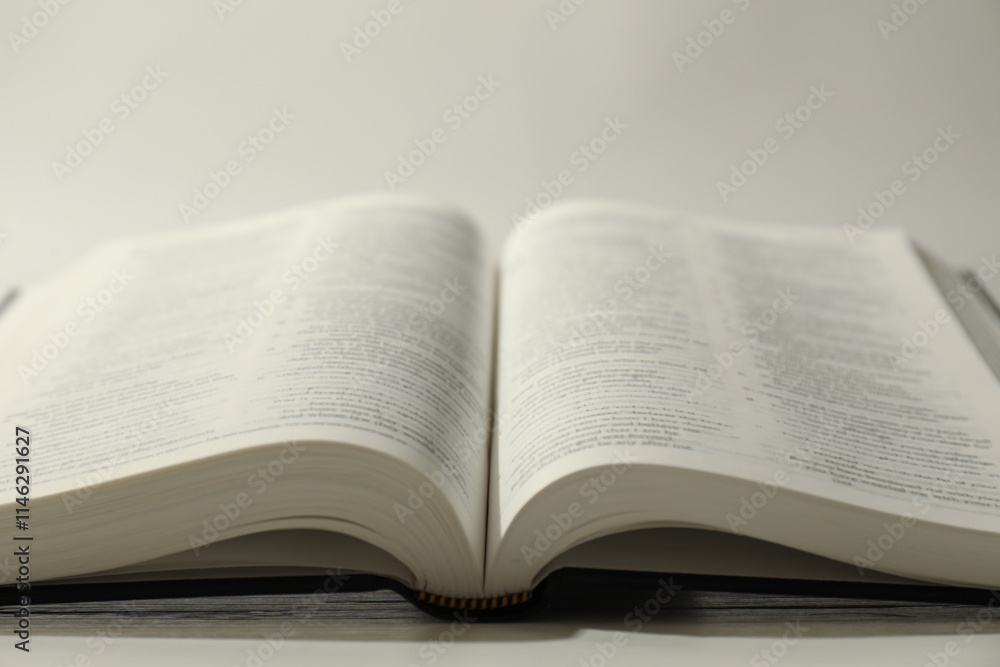 Open Holy Bible in English language on white table, closeup Open Holy Bible in English language on white table, closeup