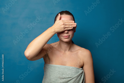 covering eyes with one hand feeling scared or anxious, wondering or blindly waiting for a surprise