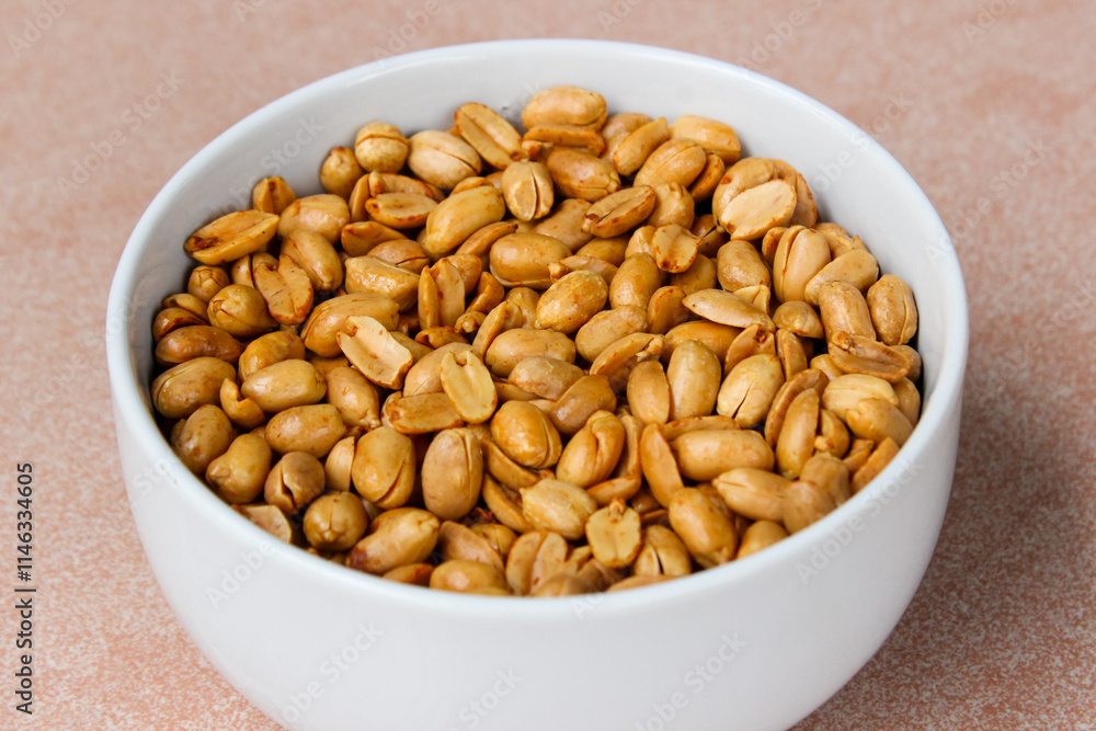 Close up of Roasted salted peanut on a white bowl Close up of Roasted salted peanut on a white bowl