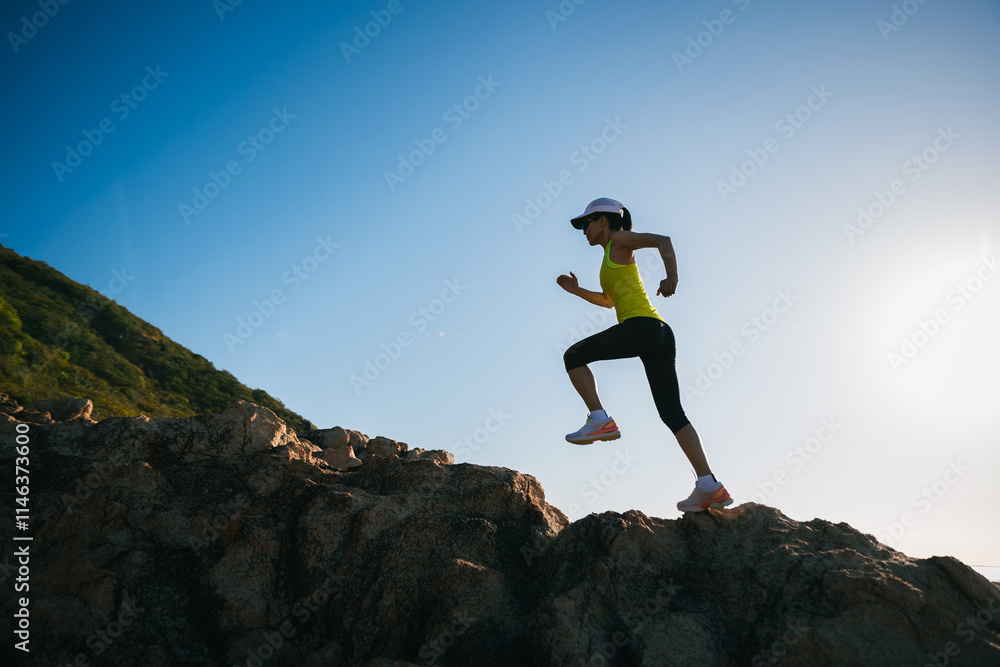 Athletic woman running on sunrise seaside rocks Athletic woman running on sunrise seaside rocks