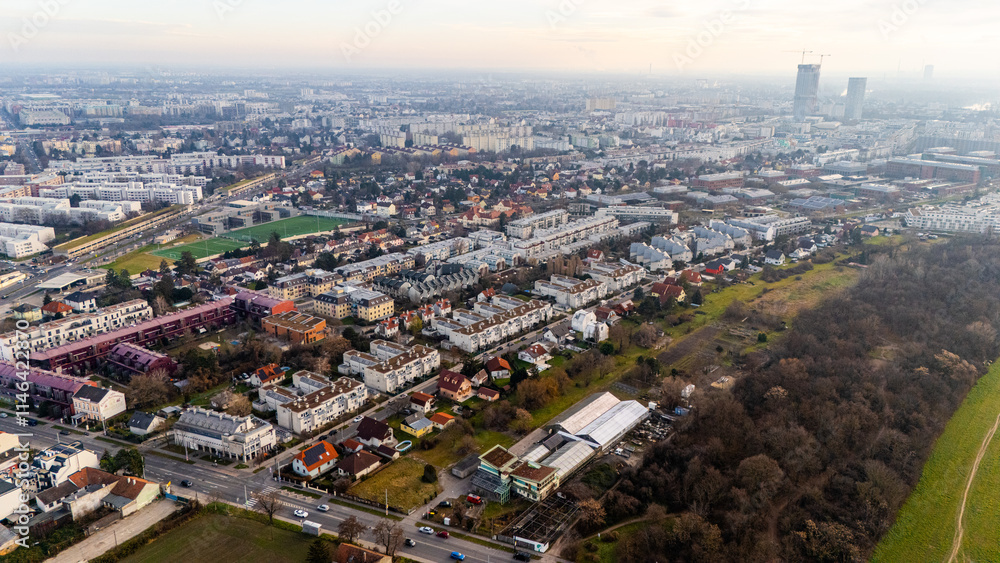 Fototapeta premium Austria, Vienna: Top Aerial View of Quiet Residential Areas in Districts 21 and 22. A peaceful perspective showcasing the serene neighborhoods of the Austrian capital