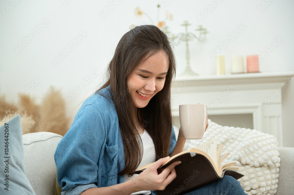 Young Asian woman enjoying reading book in living room at home Young Asian woman enjoying reading book in living room at home