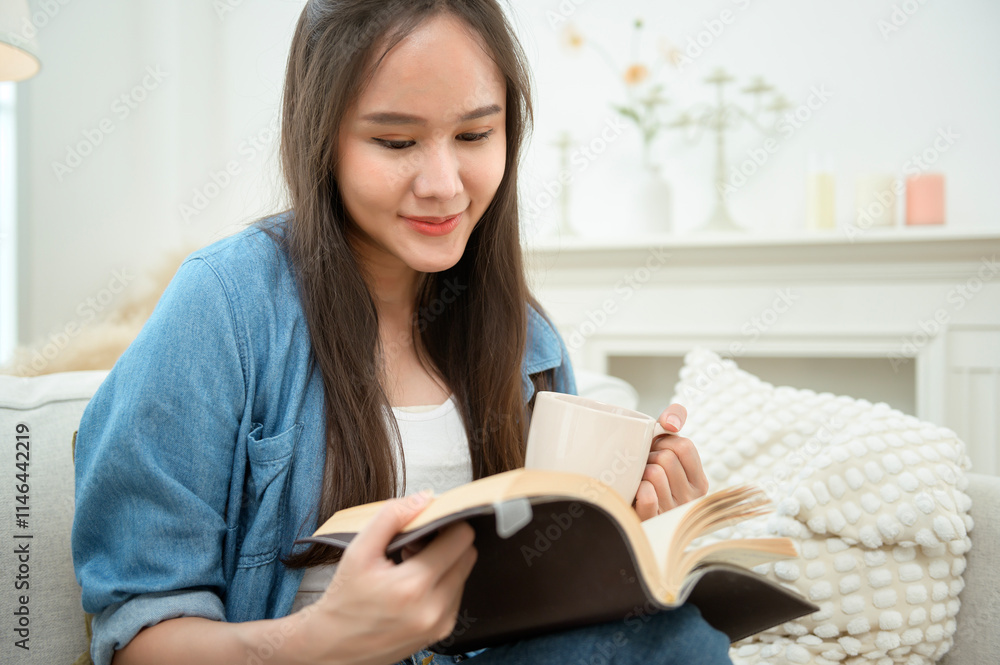 Young Asian woman enjoying reading book in living room at home Young Asian woman enjoying reading book in living room at home