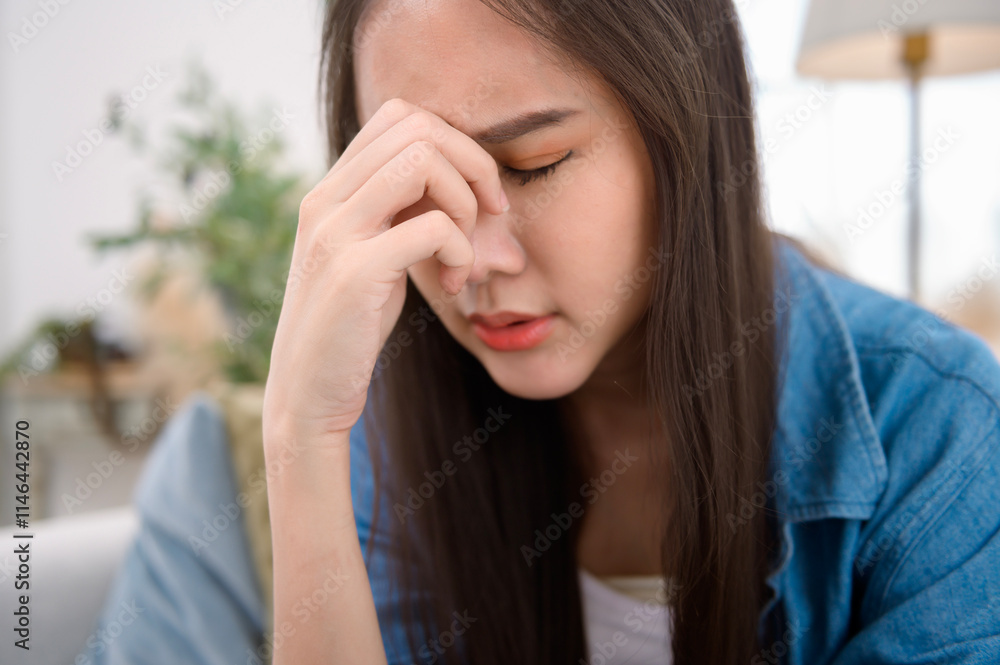 Young asian woman feeling stress in living room at home Young asian woman feeling stress in living room at home