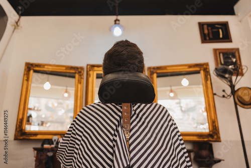 A man is getting his hair cut in a barbershop