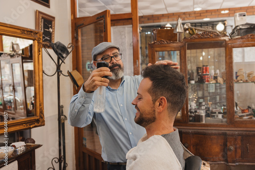 A man is getting his hair cut by another man