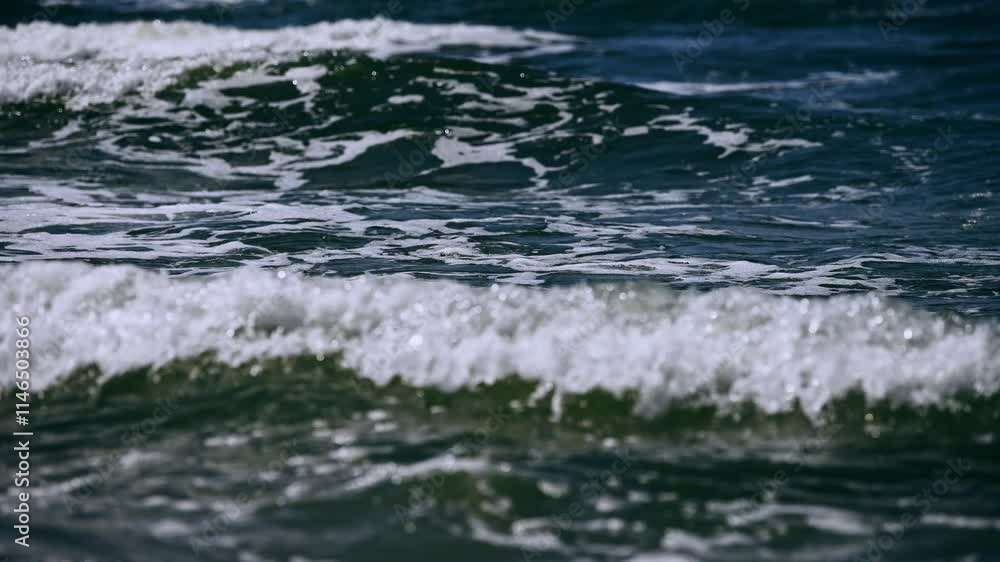 Gentle ocean waves lapping shoreline in tranquil coastal scene