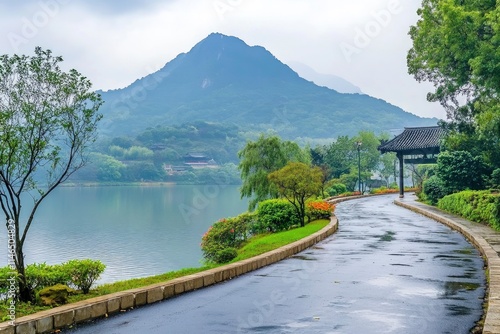 Asphalt road and mountain with lake natural scenery in Hangzhou, China. 