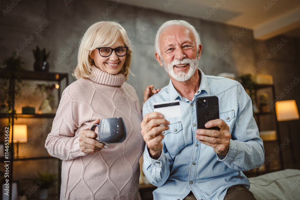 Fototapeta premium senior husband and wife buy online on cellphone with credit card