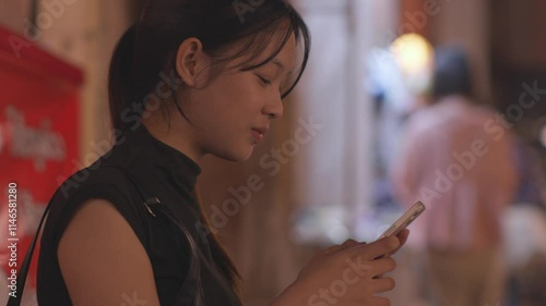 Woman using smartphone at night, Night lights, Bokeh of lights.