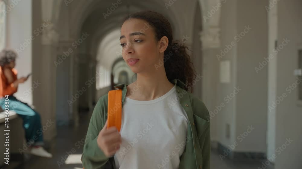 Sad frustrated Latina Hispanic student woman female walking in university college corridor hall meeting friend girl talking support multiracial students girls women friendship walk together education Sad frustrated Latina Hispanic student woman female walking in university college corridor hall meeting friend girl talking support multiracial students girls women friendship walk together education