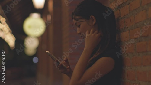 Woman using smartphone at night, Night lights, Bokeh of lights.