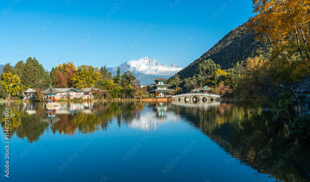 The park has morning activities. Black Dragon Pool is a park where in the morning you can see the reflection of the Jade Dragon Snow Mountain in the pond in Lijiang City, China. The park has morning activities. Black Dragon Pool is a park where in the morning you can see the reflection of the Jade Dragon Snow Mountain in the pond in Lijiang City, China.