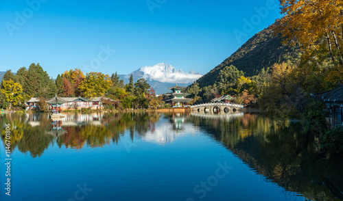 The park has morning activities. Black Dragon Pool is a park where in the morning you can see the reflection of the Jade Dragon Snow Mountain in the pond in Lijiang City, China. photo