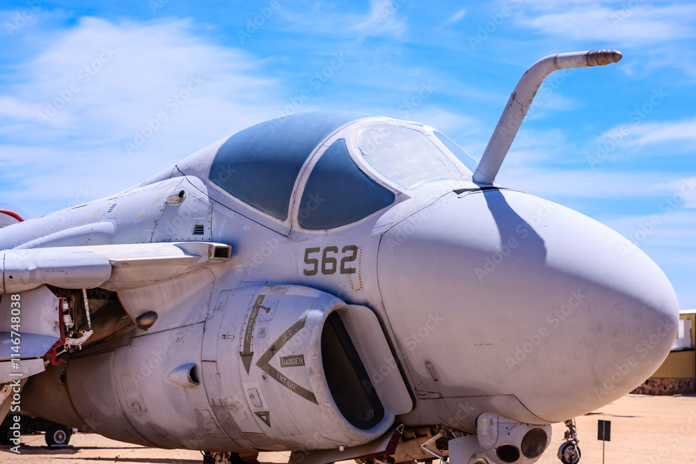 A white fighter jet with the number 562 on the side A white fighter jet with the number 562 on the side
