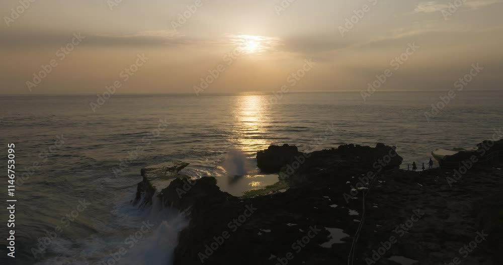 A serene aerial dusk overview of Devil's Tears in Nusa Lembongan, waves crashing amid fading light A serene aerial dusk overview of Devil's Tears in Nusa Lembongan, waves crashing amid fading light