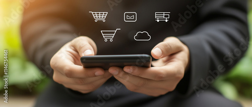 A person is using a mobile phone outdoors, with icons for a shopping cart, email, document, and cloud visible on the screen.
