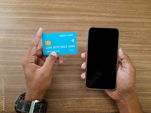 Man Holding Credit Card and Smartphone