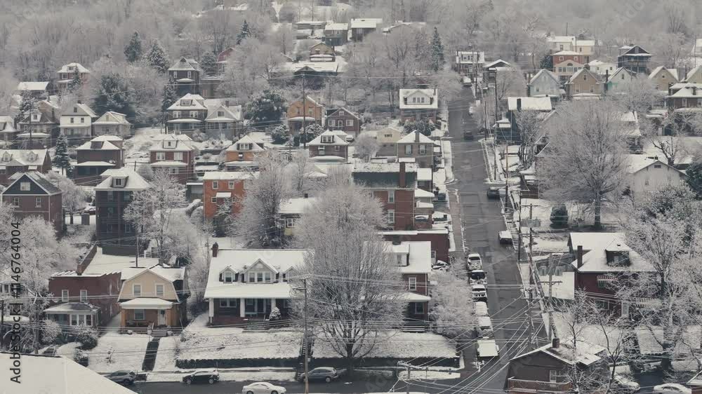 A sideways-moving aerial establishing shot view of typical Pennsylvania homes in the winter. Pittsburgh suburbs. A sideways-moving aerial establishing shot view of typical Pennsylvania homes in the winter. Pittsburgh suburbs.