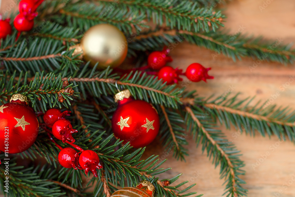 New Year's background made of wood with a Christmas tree branch and framed by New Year's baubles. New Year's background made of wood with a Christmas tree branch and framed by New Year's baubles.