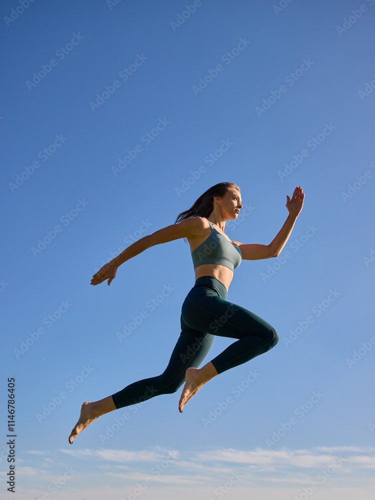female person jumping in the air wearing green fitness outfit female person jumping in the air wearing green fitness outfit