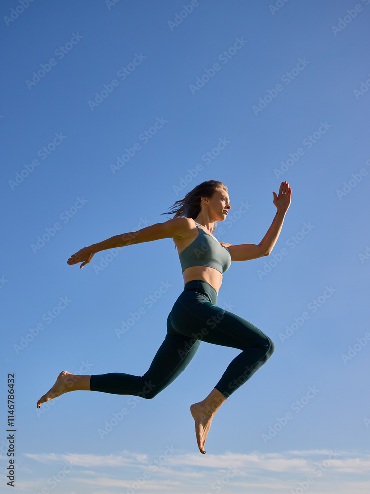 female person jumping in the air wearing green fitness outfit female person jumping in the air wearing green fitness outfit