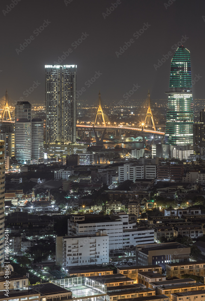 Night view after sunset of Skyscrapers in the business district and Bhumibol Bridge. Beautiful city of Bangkok with bright glowing lights in the sundown, use it as your Wallpaper, Poster andCopy space