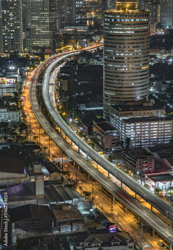 Obraz na płótnie Night scene of light trails of cars on the road of Bangkok city. Nightscape view of with bright glowing lights after sunset, Long exposure for Light curve lines, use it as your Wallpaper, Poster. w salonie
