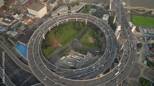 Wallpaper Mural SHANGHAI, CHINA - NOVEMBER 7, 2024: aerial view of bustling highway circular interchange with green spaces and urban landscape in shanghai Torontodigital.ca